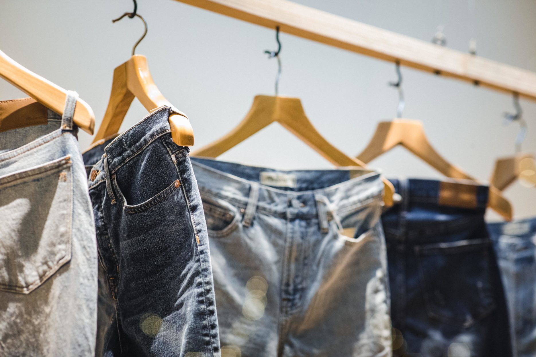 Jeans hanging up on a rack