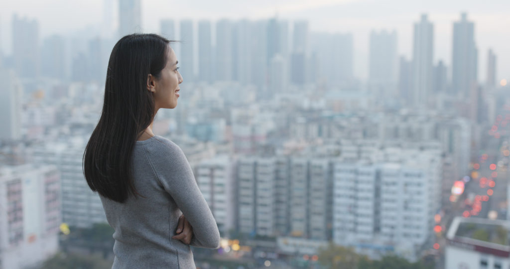 Chinese woman staring out over the city