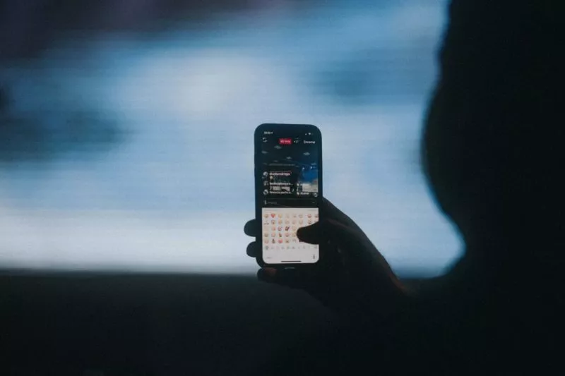 Silhouette of man holding an iPhone