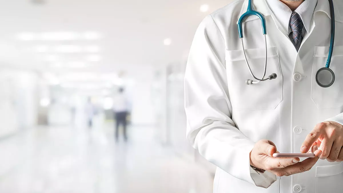 Male doctor using mobile phone at hospital