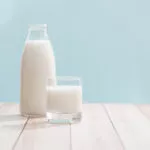 Glass of milk and milk bottle