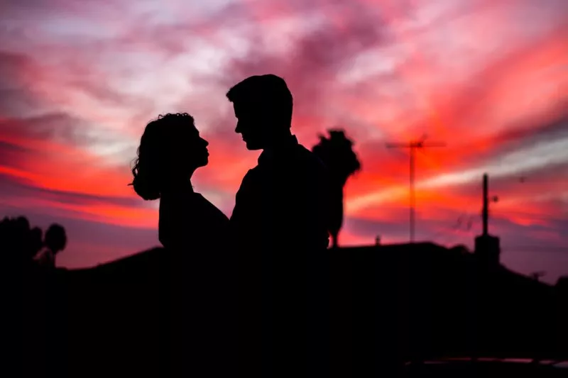 Couple hugging at sunset