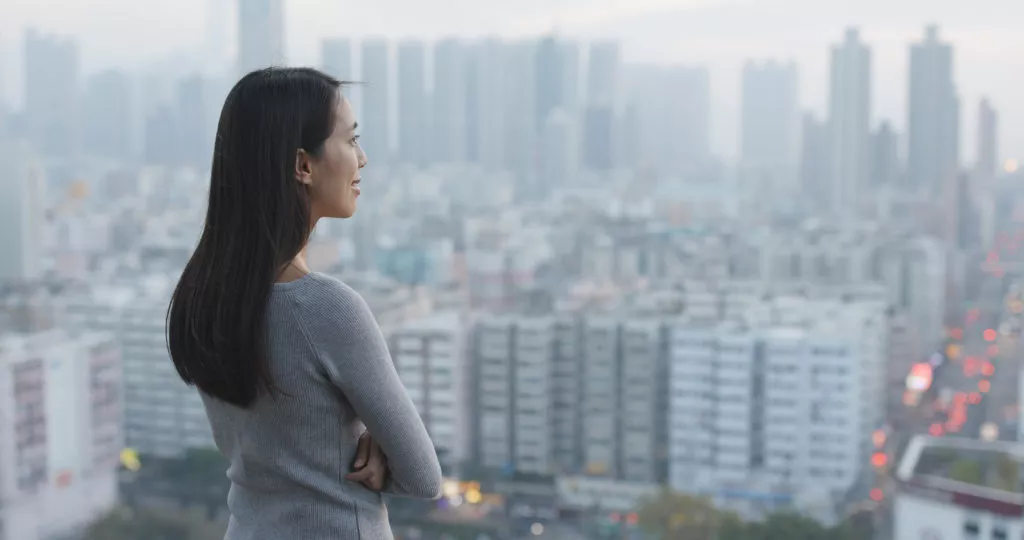 Chinese woman staring out over the city