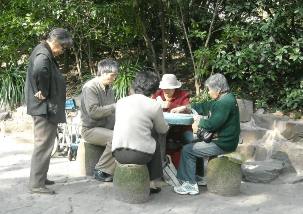 A group of Chinese elderly playing mahjong in Shanghai