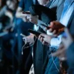 Users look at mobile phones. Credit: Unsplash
