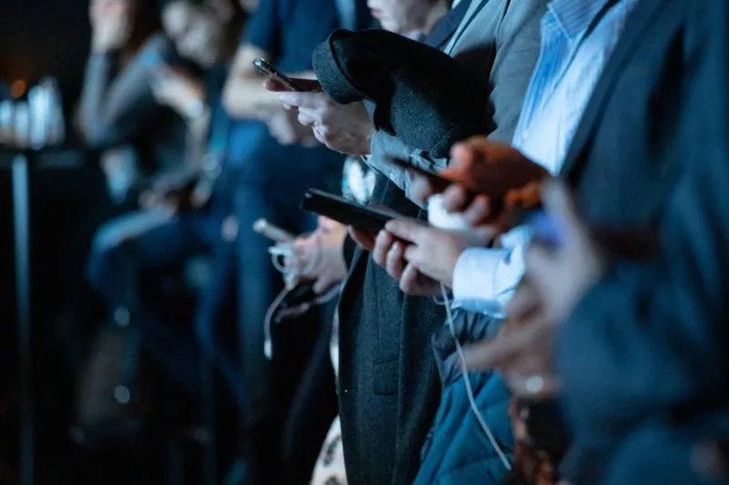 Users look at mobile phones. Credit: Unsplash