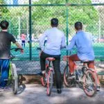Cyclists watch football in China. Credit: Unsplash